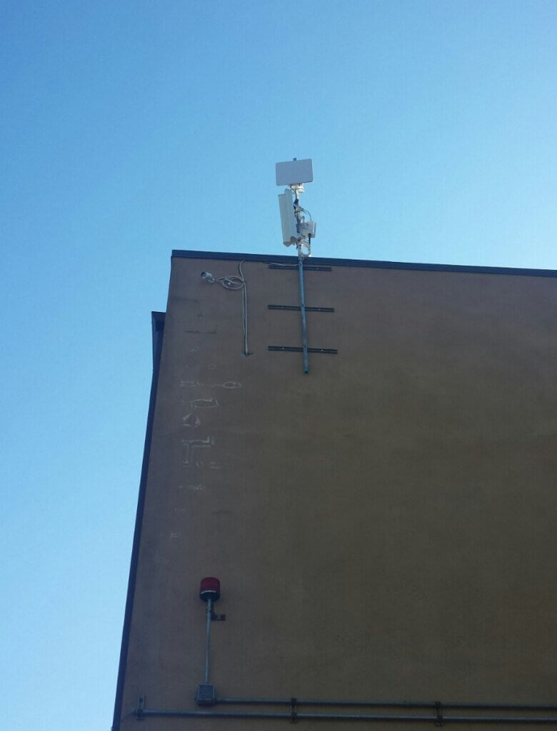 Outdoor Access Point installed on the side of building