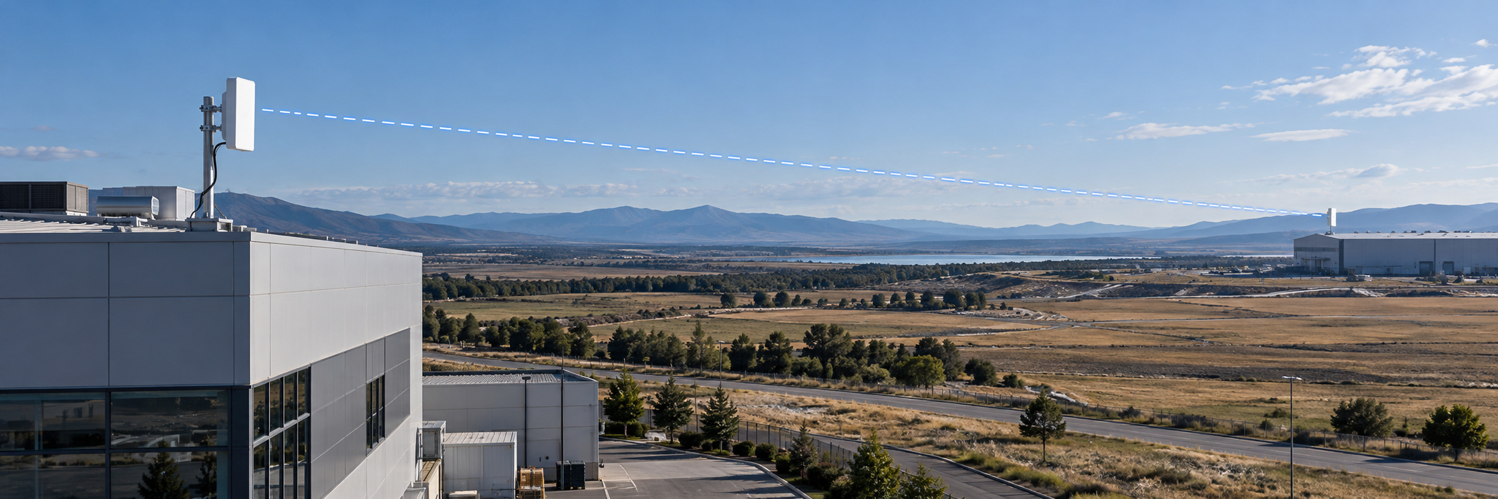 Directional wireless bridge connecting two commercial buildings across an open landscape